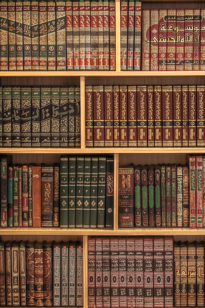 services-01 A collection of Islamic books neatly arranged on wooden shelves showcasing rich cultural heritage.